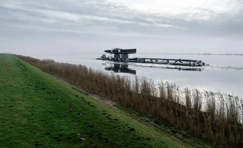 a body of water with a bridge and a building on the other side aboard NILAYA Yacht for Sale