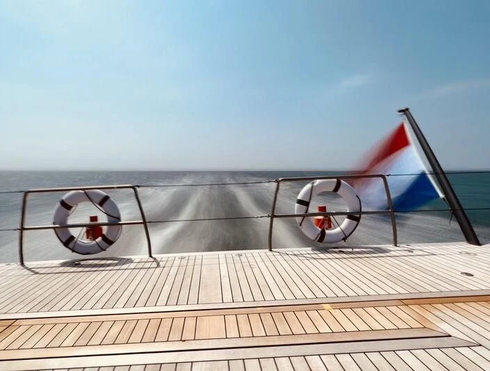 a deck with a flag and a boat on it aboard NILAYA Yacht for Sale