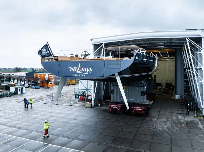 a large airplane is parked at a loading dock aboard NILAYA Yacht for Sale