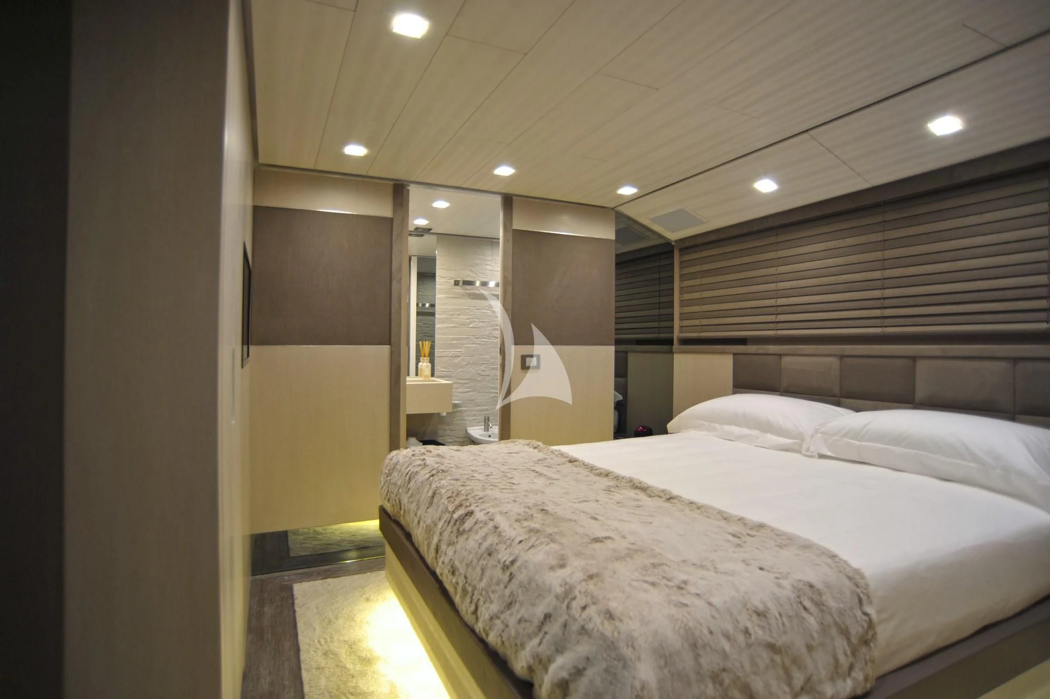 a room with a bed and a mirror aboard IROCK Yacht for Sale