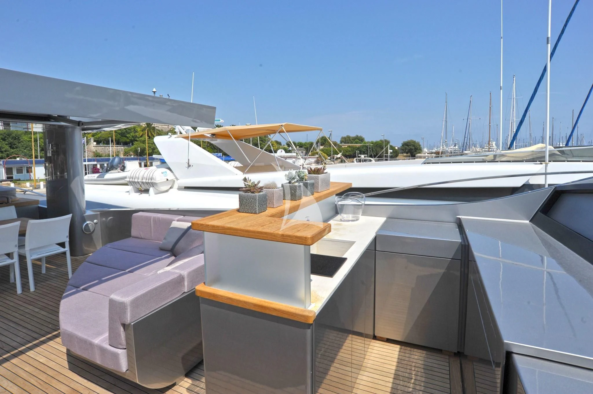 a deck with a table and chairs aboard IROCK Yacht for Sale