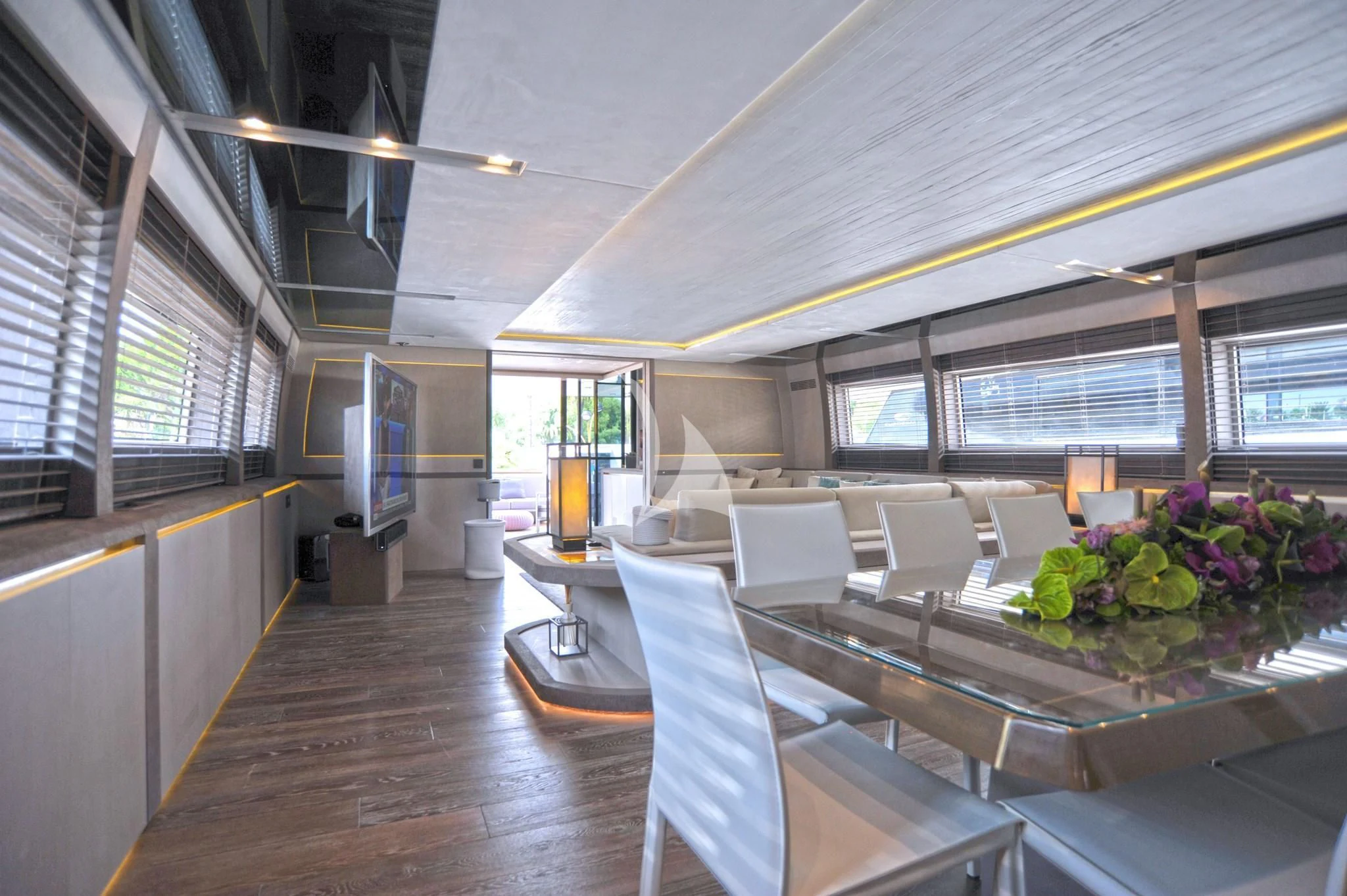 a room with tables and chairs aboard IROCK Yacht for Sale