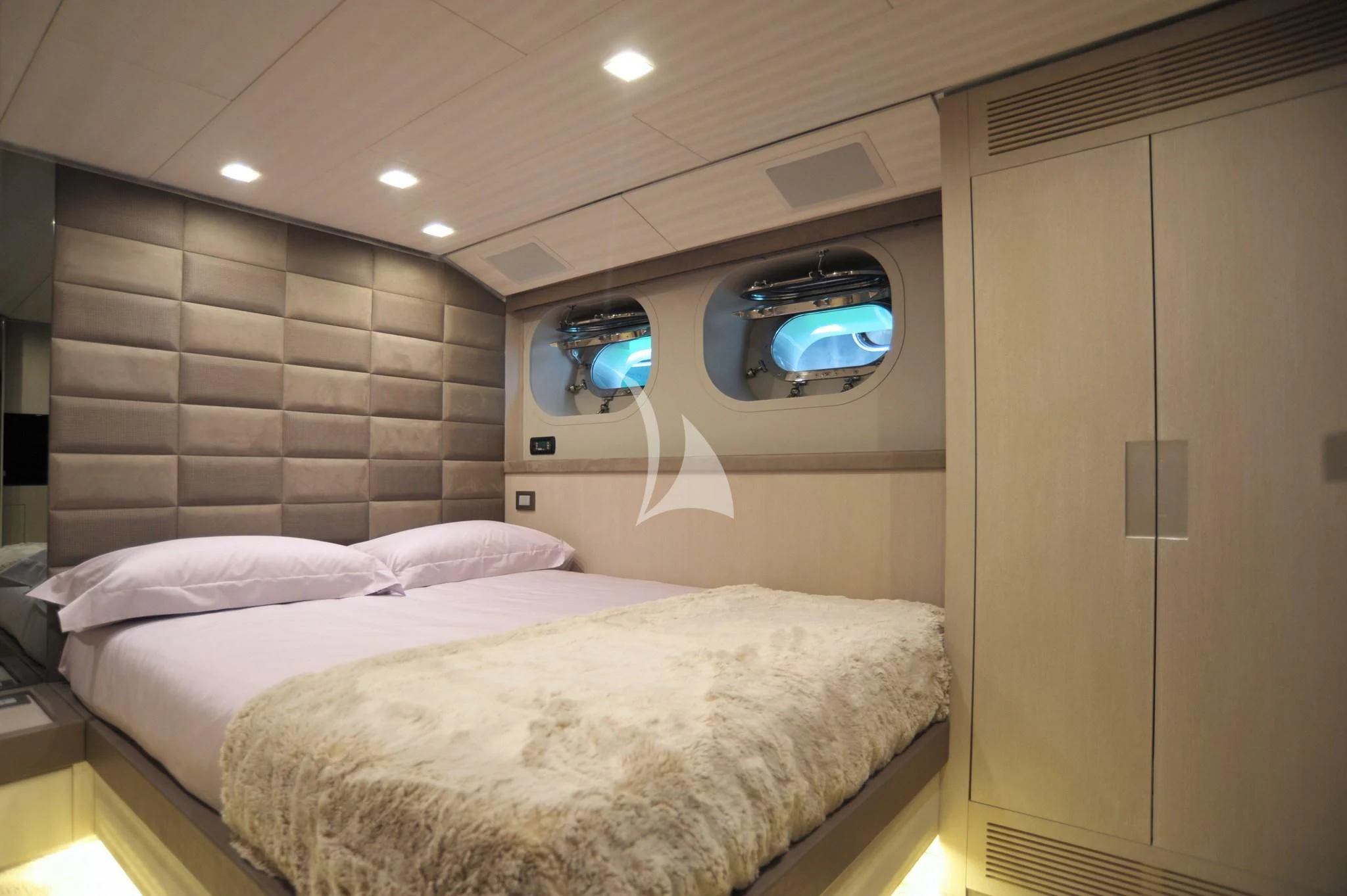 a bedroom with a bed and a mirror aboard IROCK Yacht for Sale