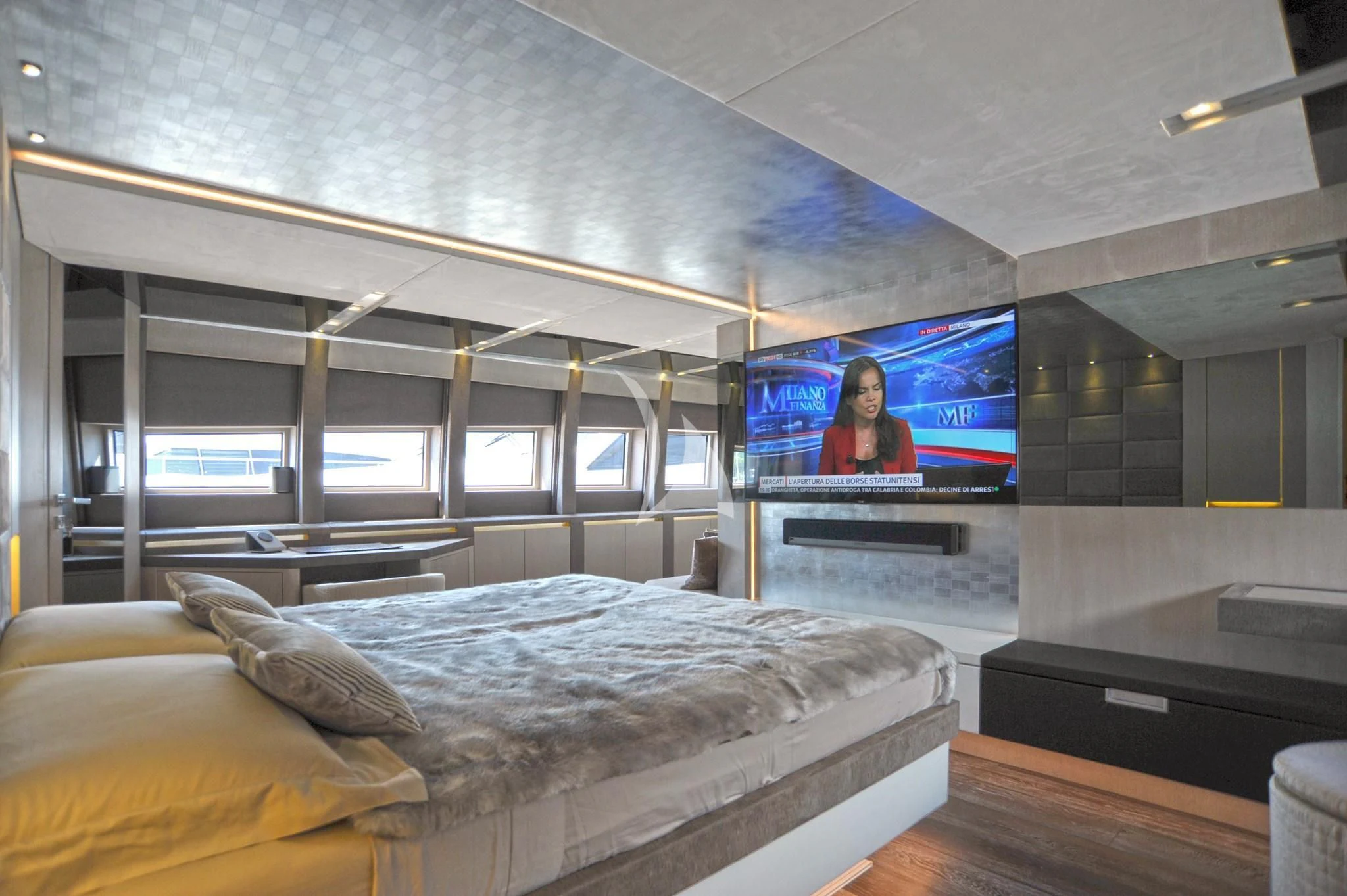a large room with a bed and a tv aboard IROCK Yacht for Sale
