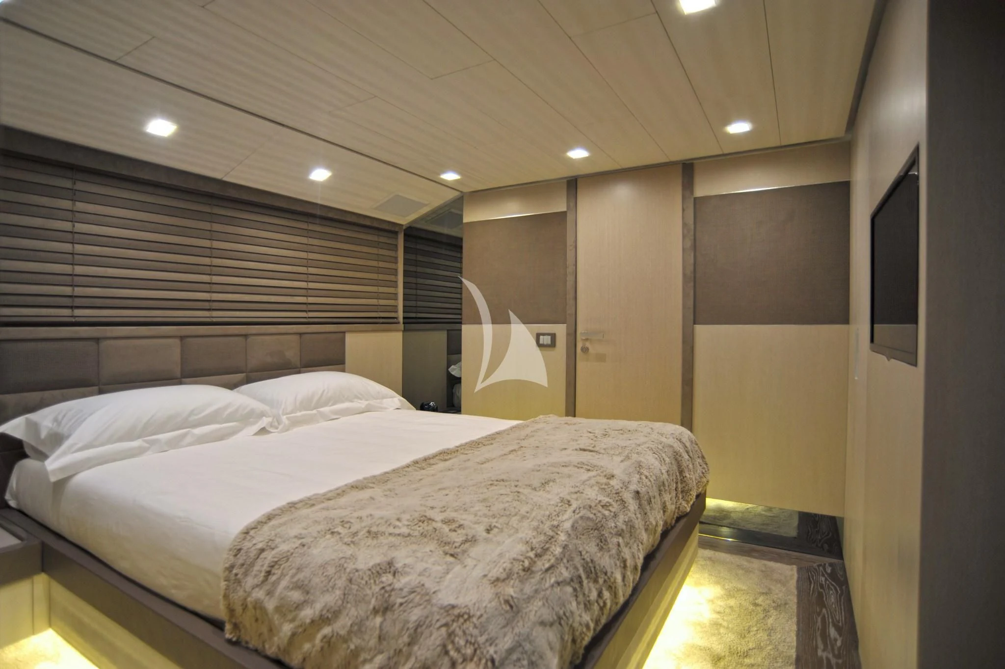 a room with a bed and a mirror aboard IROCK Yacht for Sale
