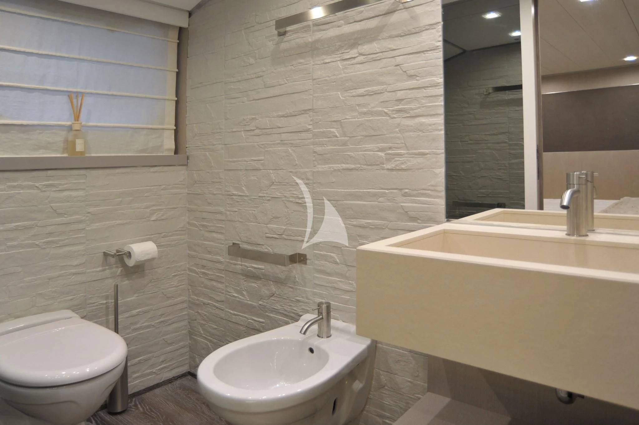 a bathroom with a sink toilet and bathtub aboard IROCK Yacht for Sale
