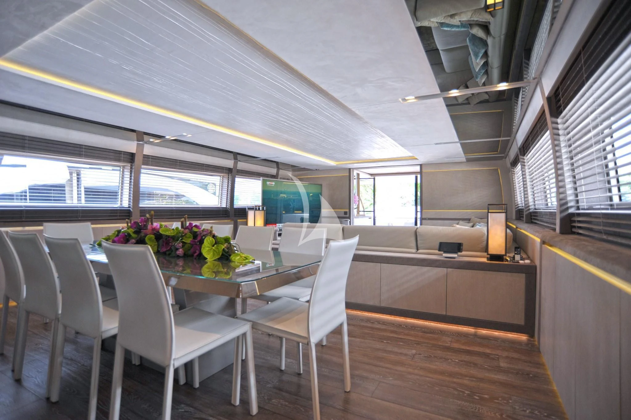 a room with tables and chairs aboard IROCK Yacht for Sale