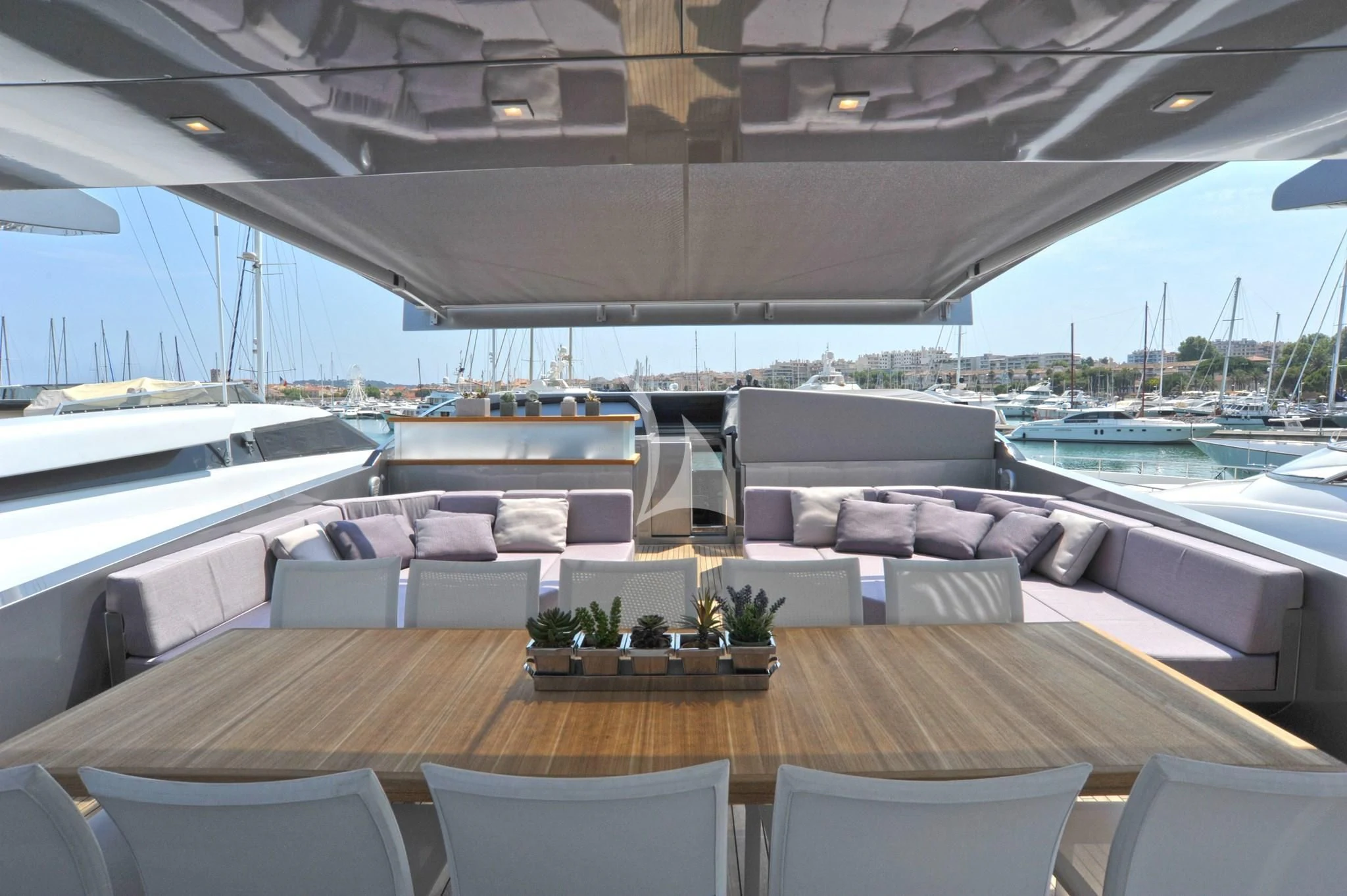 a large room with a table and chairs aboard IROCK Yacht for Sale