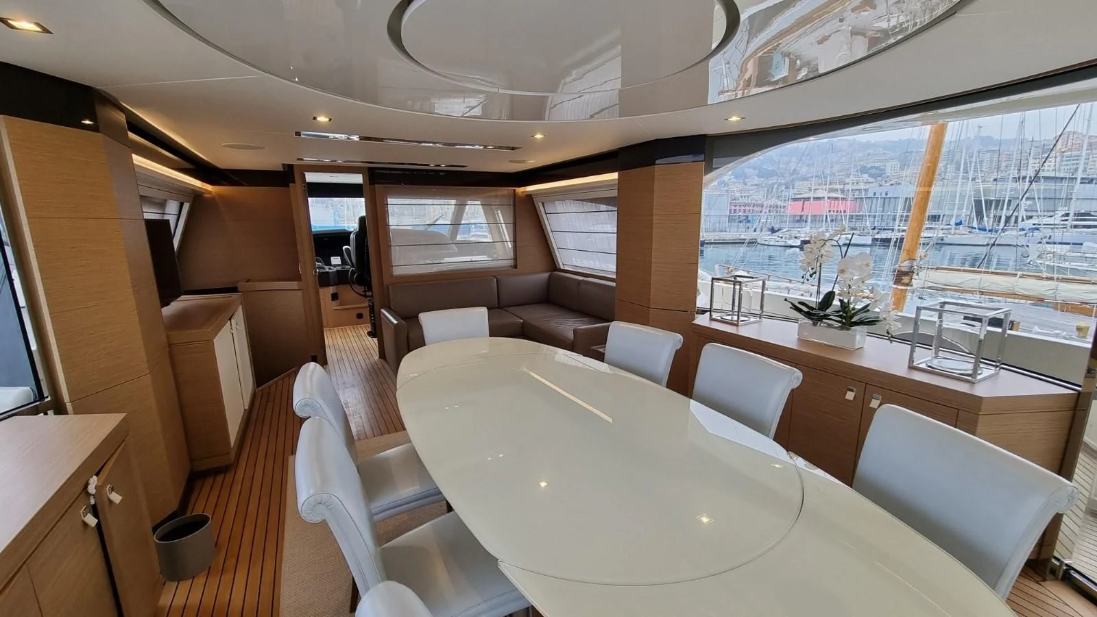 a room with a table chairs and a view of a city aboard MERIDIANA Yacht for Sale