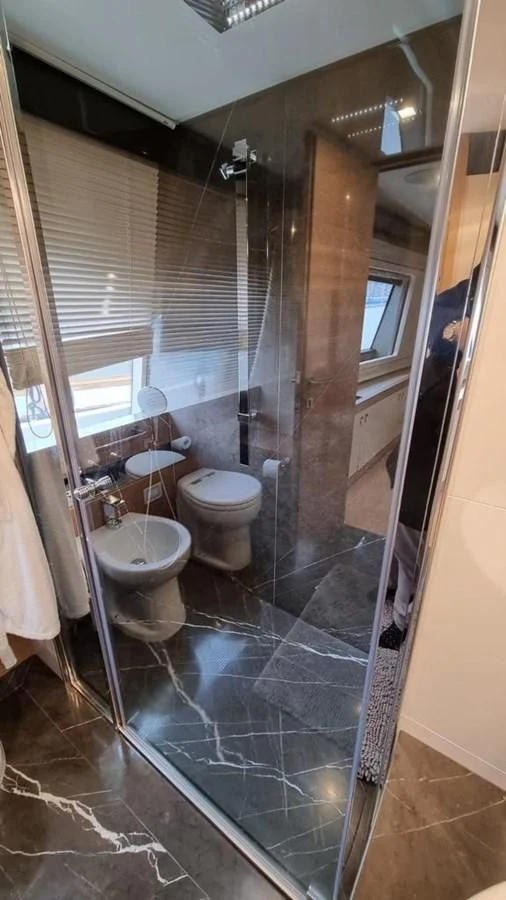 a bathroom with a glass shower aboard MERIDIANA Yacht for Sale