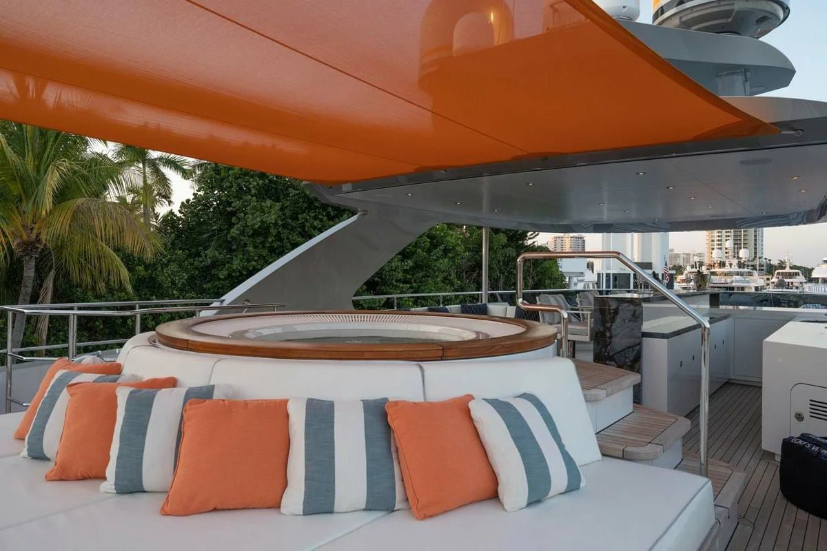 a large lounge area with a large lounge chair and a large umbrella aboard INFINITY Yacht for Sale