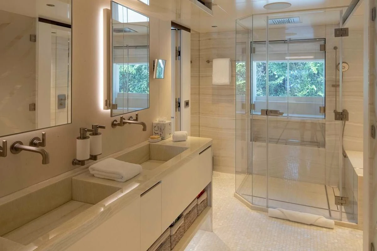 a bathroom with a glass shower aboard INFINITY Yacht for Sale