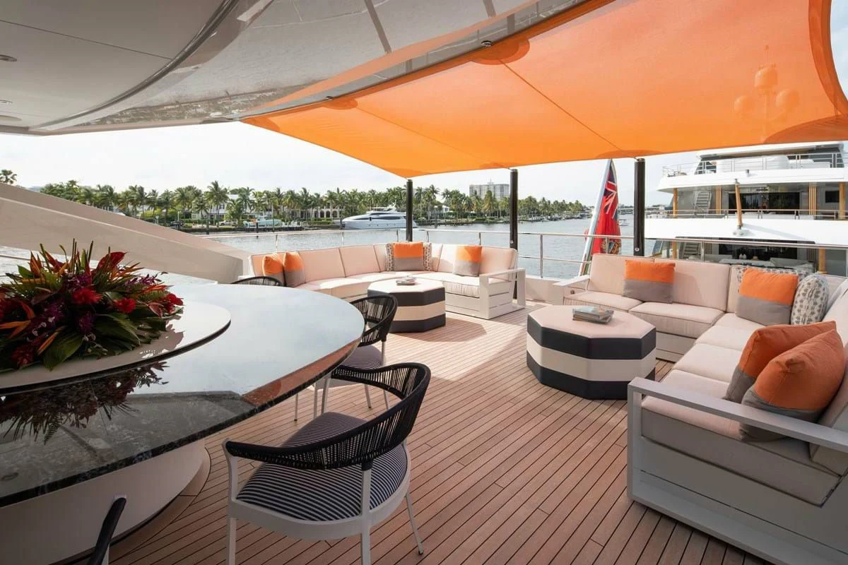 a large patio with a table and chairs and a large umbrella aboard INFINITY Yacht for Sale