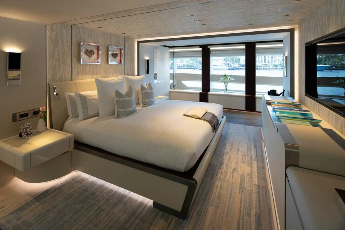 a room with a bed and a large window aboard INFINITY Yacht for Sale