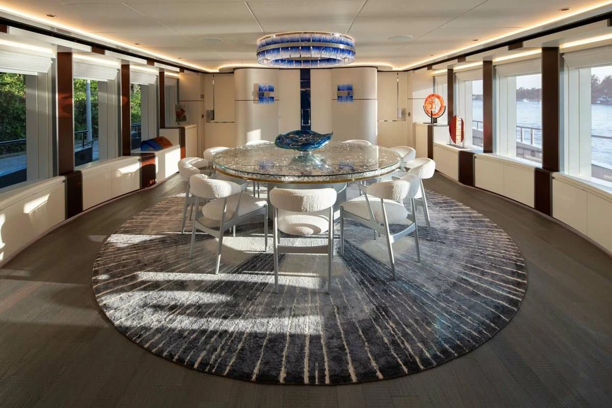 a large room with a table and chairs aboard INFINITY Yacht for Sale