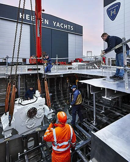 a group of men working on a large machine aboard INFINITY Yacht for Sale