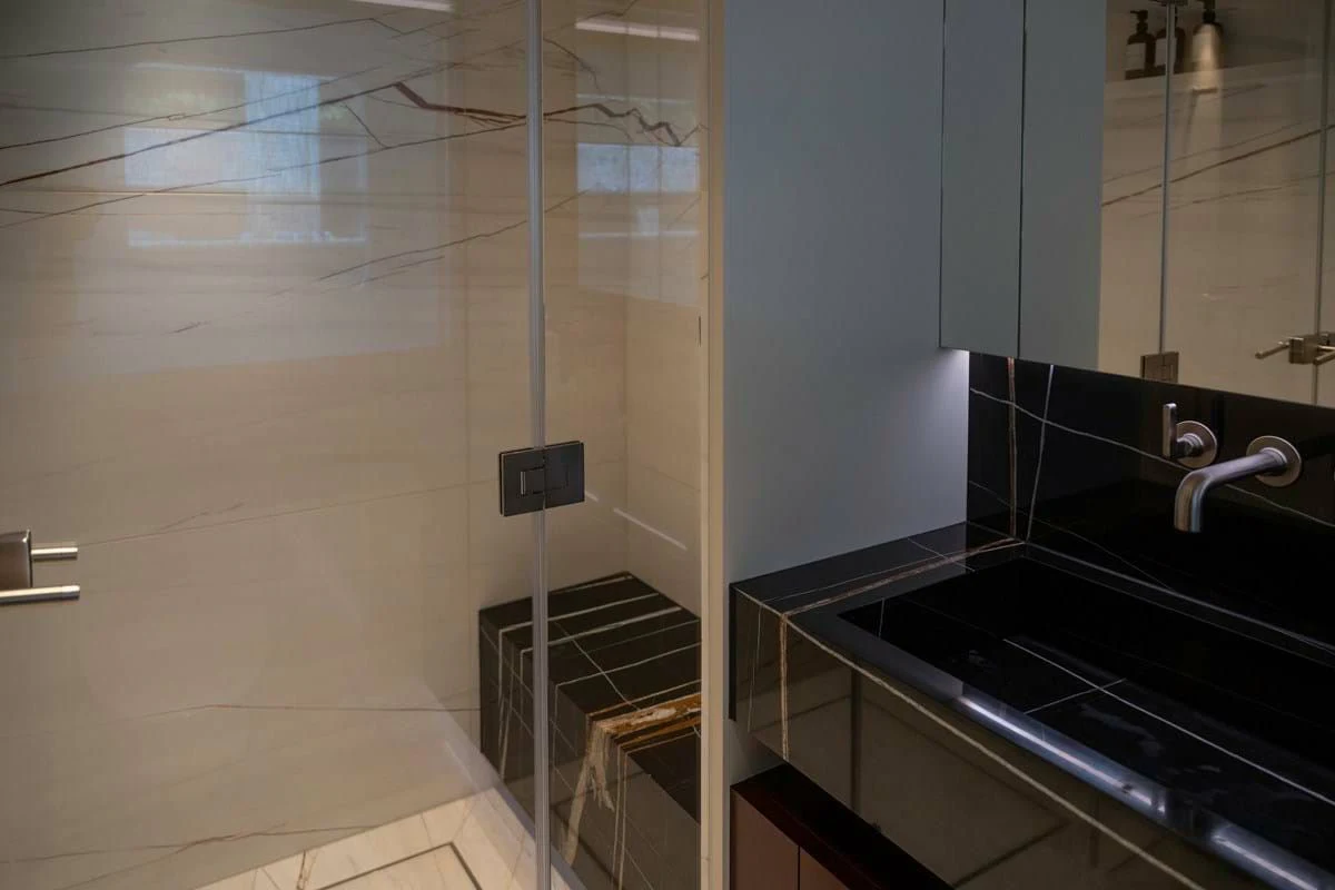 a bathroom with a glass shower aboard INFINITY Yacht for Sale