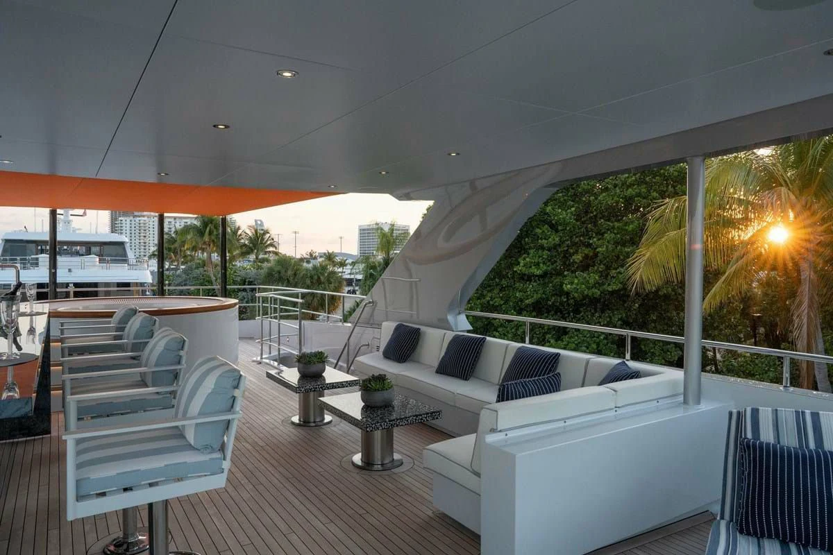a patio with a table and chairs aboard INFINITY Yacht for Sale
