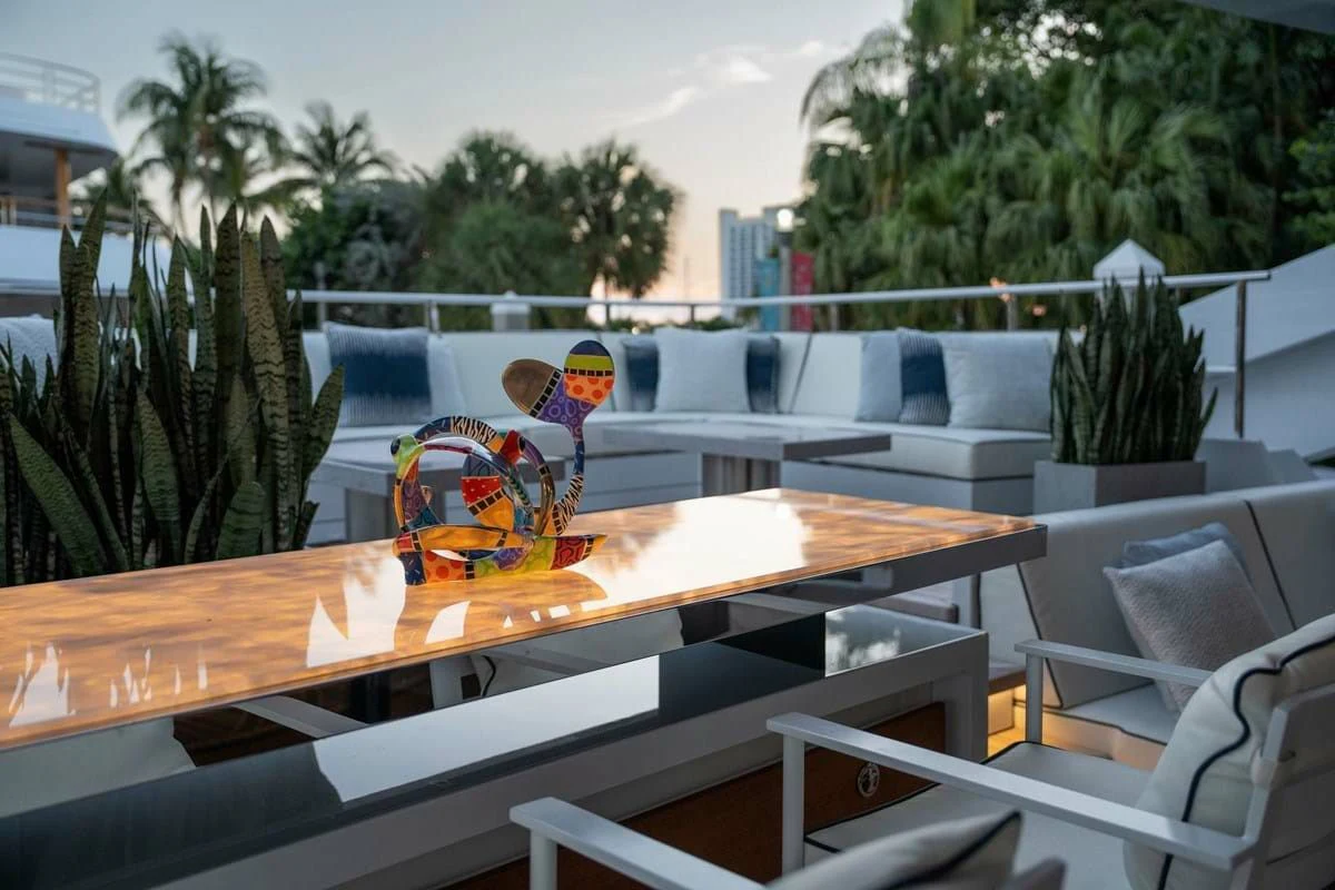 a table with chairs and a toy aboard INFINITY Yacht for Sale
