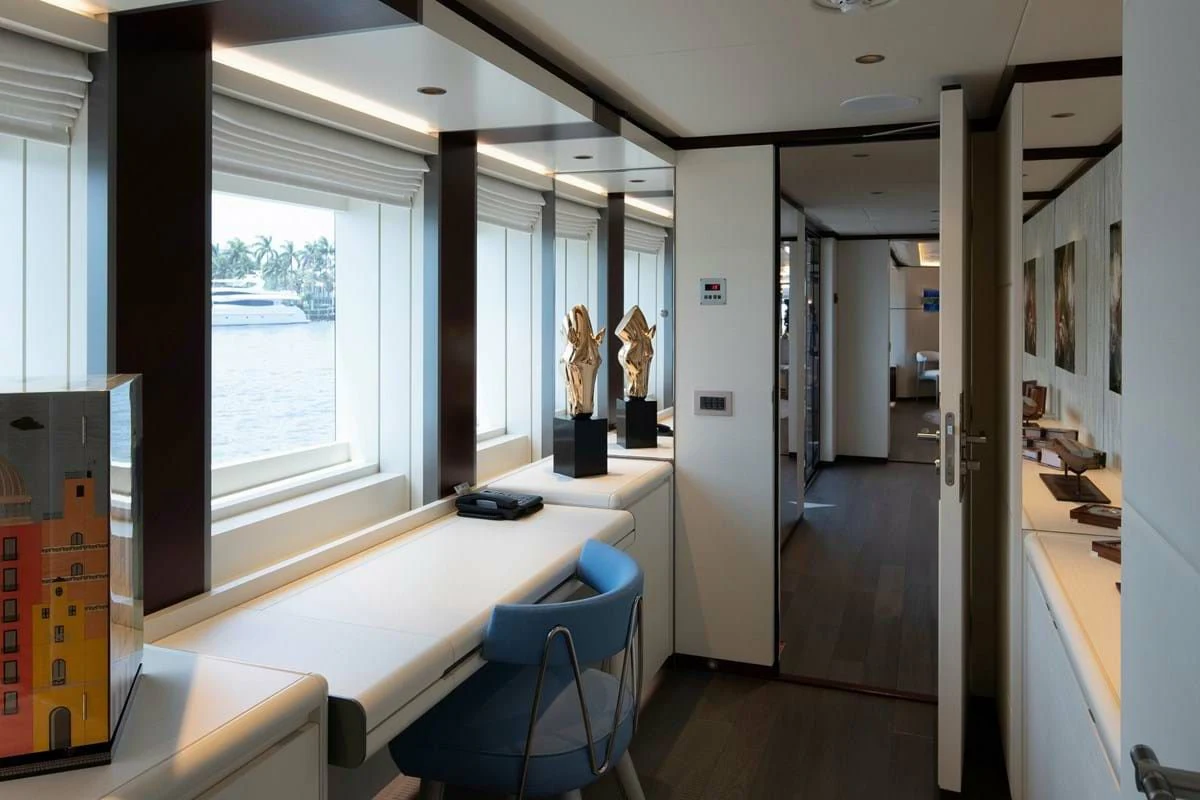 a room with a desk and a window aboard INFINITY Yacht for Sale