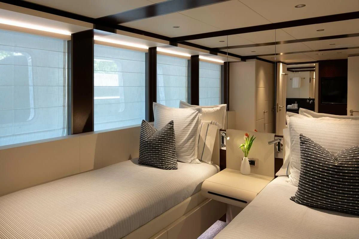 a room with a bed and a window aboard INFINITY Yacht for Sale