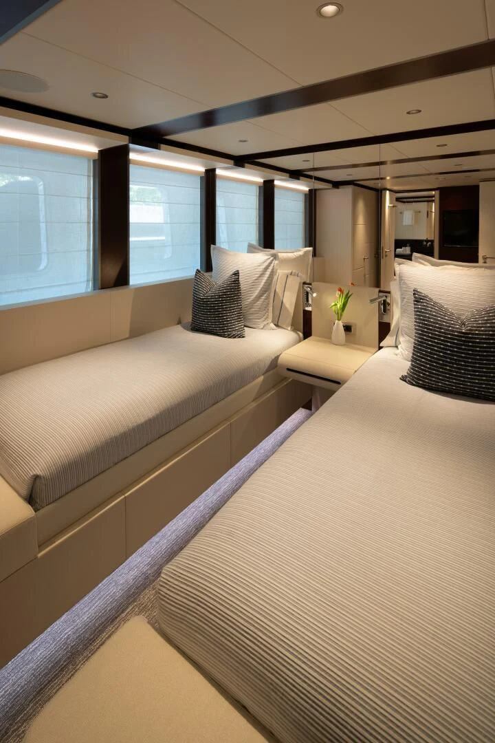 a room with a couple of beds aboard INFINITY Yacht for Sale