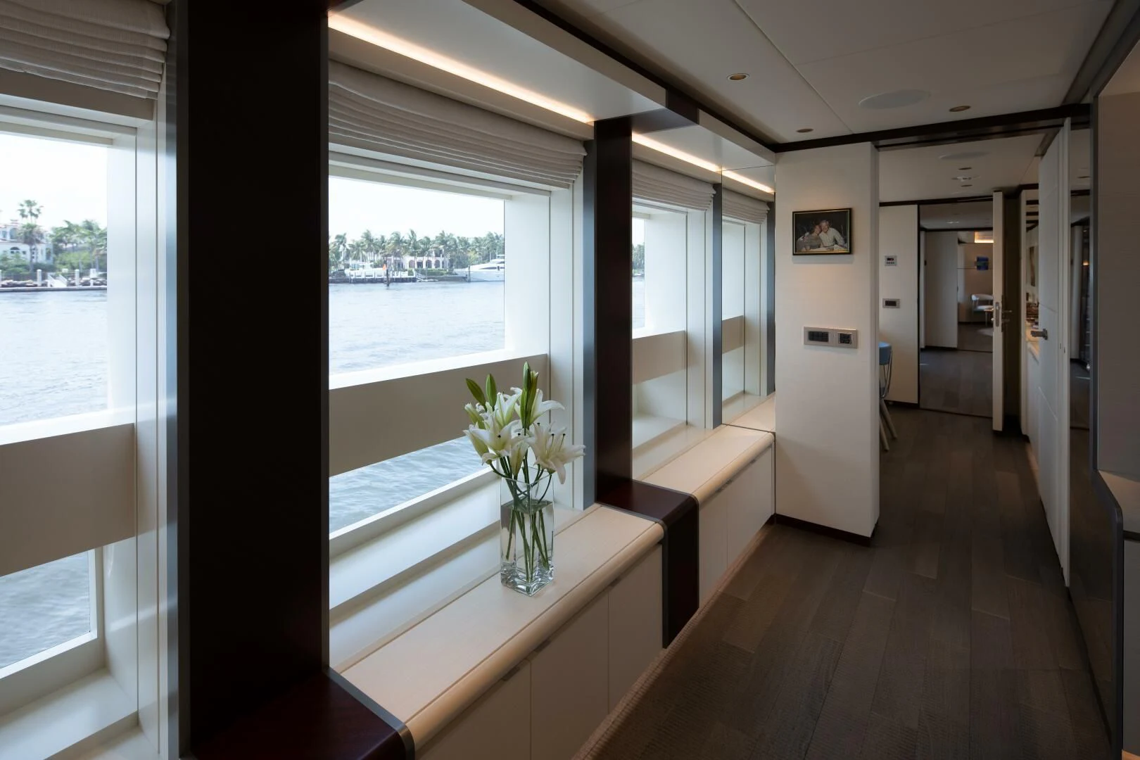 a room with a large window and a wood floor aboard INFINITY Yacht for Sale