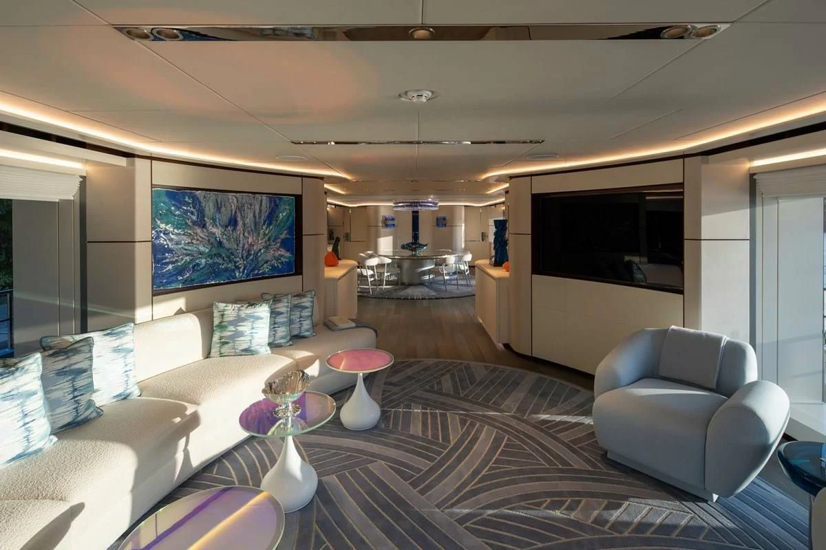 a living room with a large screen aboard INFINITY Yacht for Sale