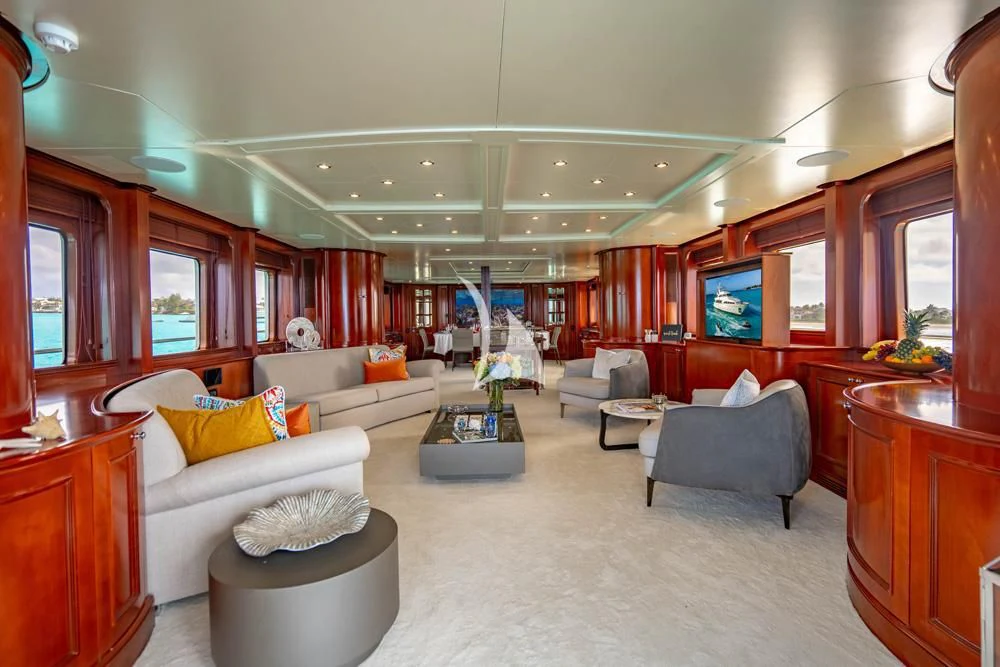 a living room with a couch and a television aboard HEAVEN CAN WAIT Yacht for Charter
