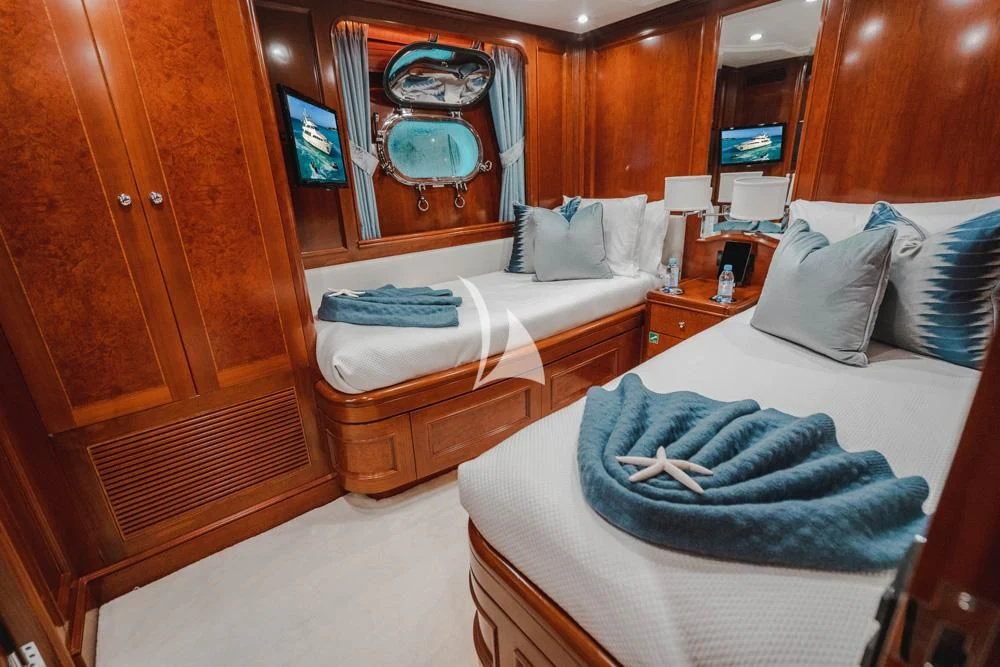 a room with a bed and a mirror aboard HEAVEN CAN WAIT Yacht for Charter