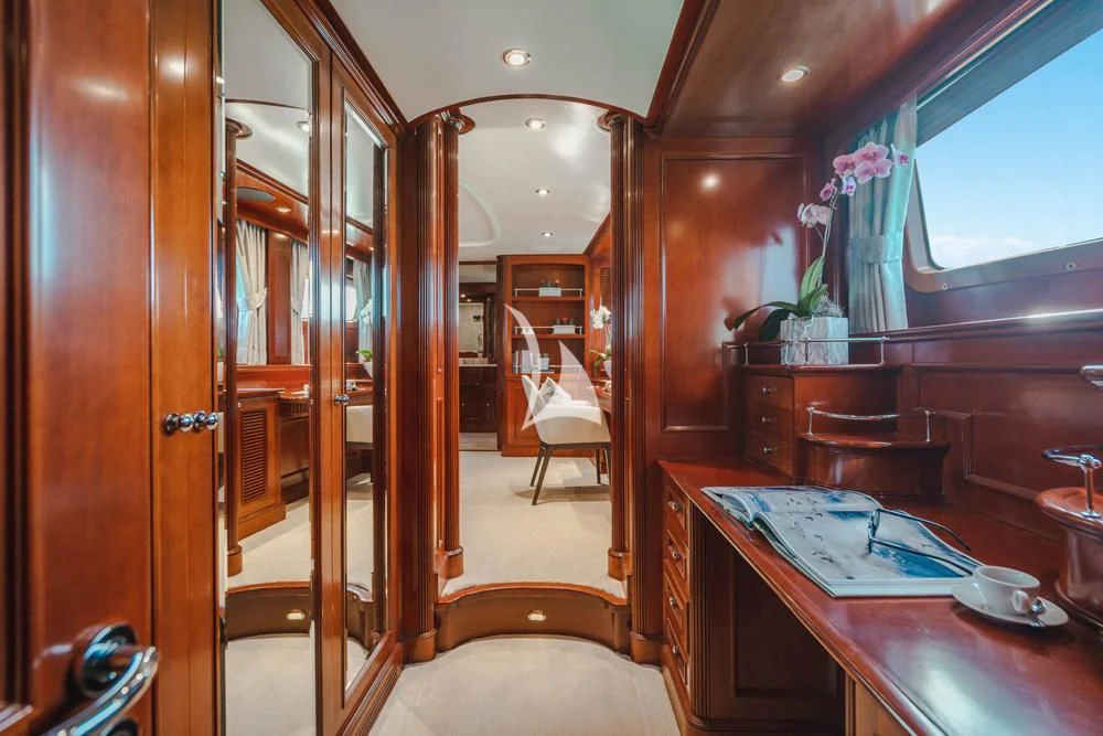 a room with a wood door and a table with chairs and a wood door aboard HEAVEN CAN WAIT Yacht for Charter