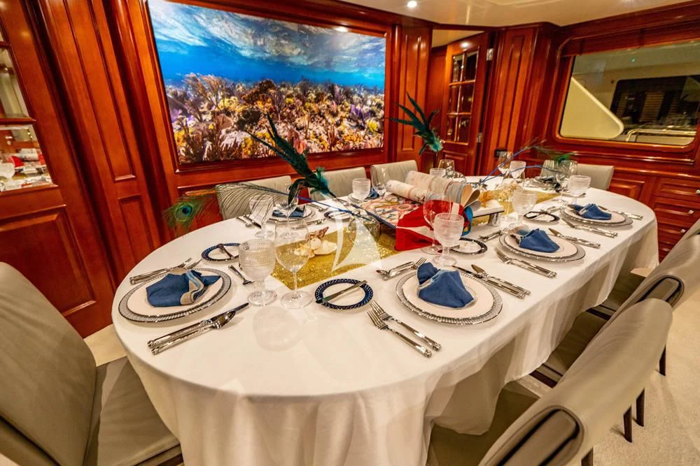 a table with plates and glasses aboard HEAVEN CAN WAIT Yacht for Charter