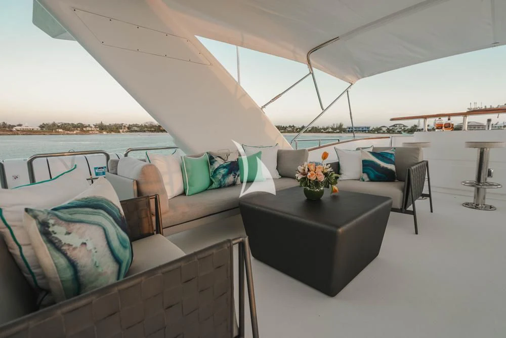 a room with a couch and a table and a chair aboard HEAVEN CAN WAIT Yacht for Charter