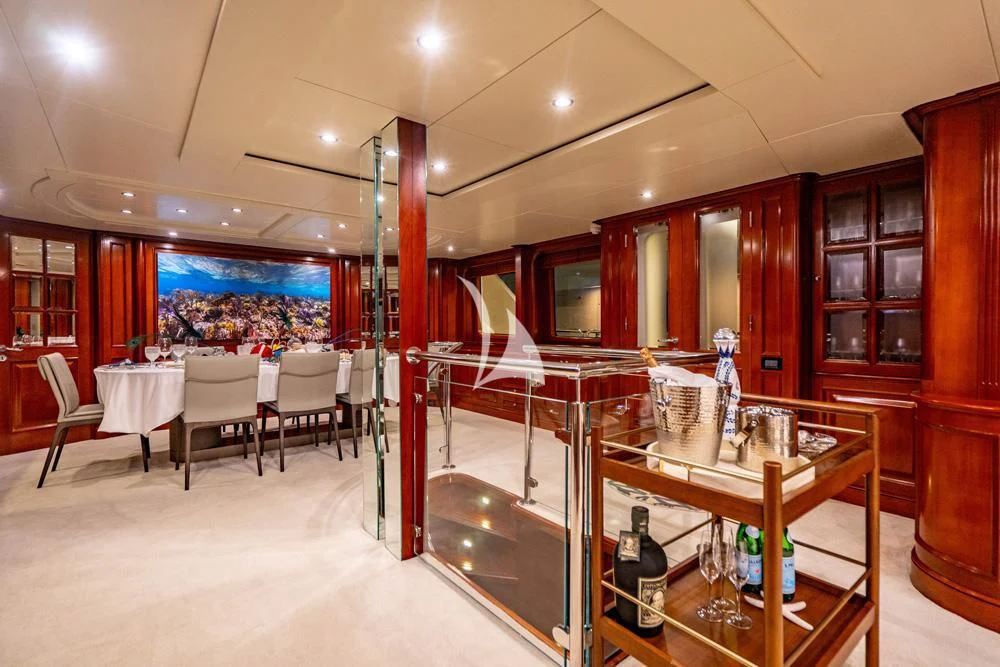 a room with tables and chairs aboard HEAVEN CAN WAIT Yacht for Charter