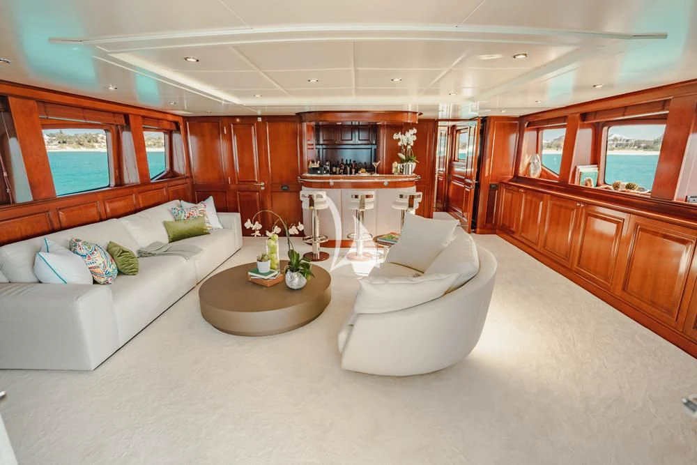 a living room with a couch and a coffee table aboard HEAVEN CAN WAIT Yacht for Charter