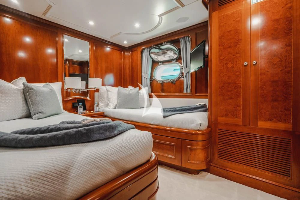 a room with a bed and a mirror aboard HEAVEN CAN WAIT Yacht for Charter