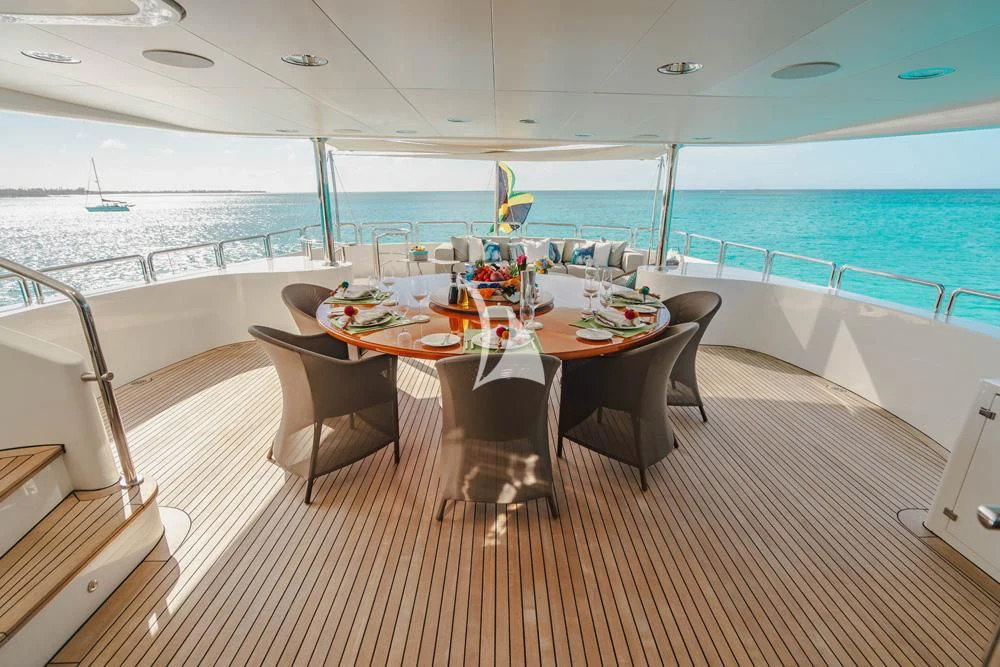 a table with chairs around it aboard HEAVEN CAN WAIT Yacht for Charter