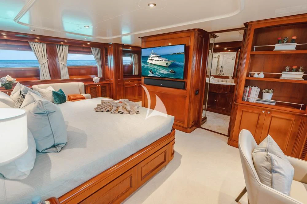 a bedroom with a bed and a tv aboard HEAVEN CAN WAIT Yacht for Charter