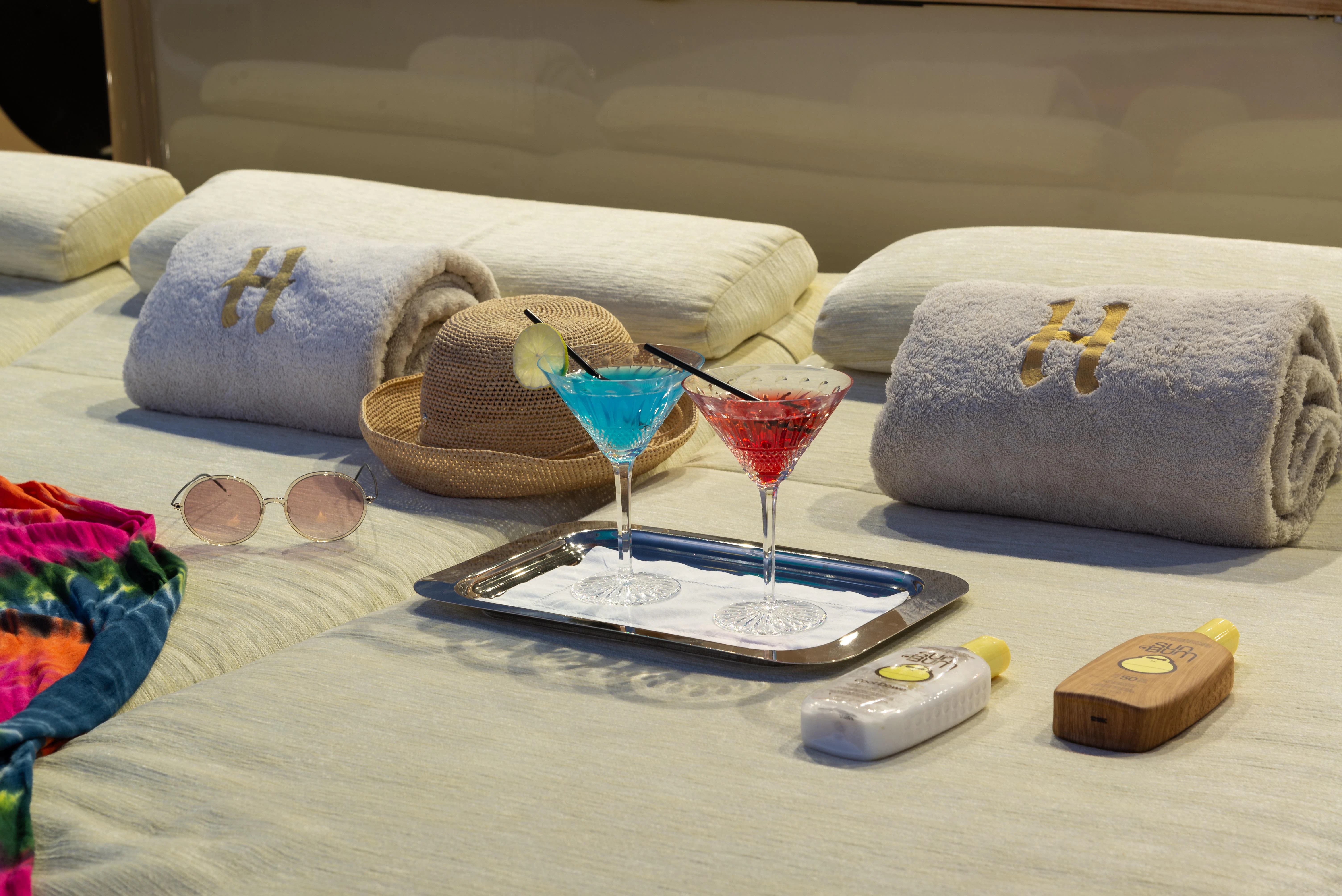 a table with a glass and a plate with food on it aboard HOKULANI Yacht for Sale