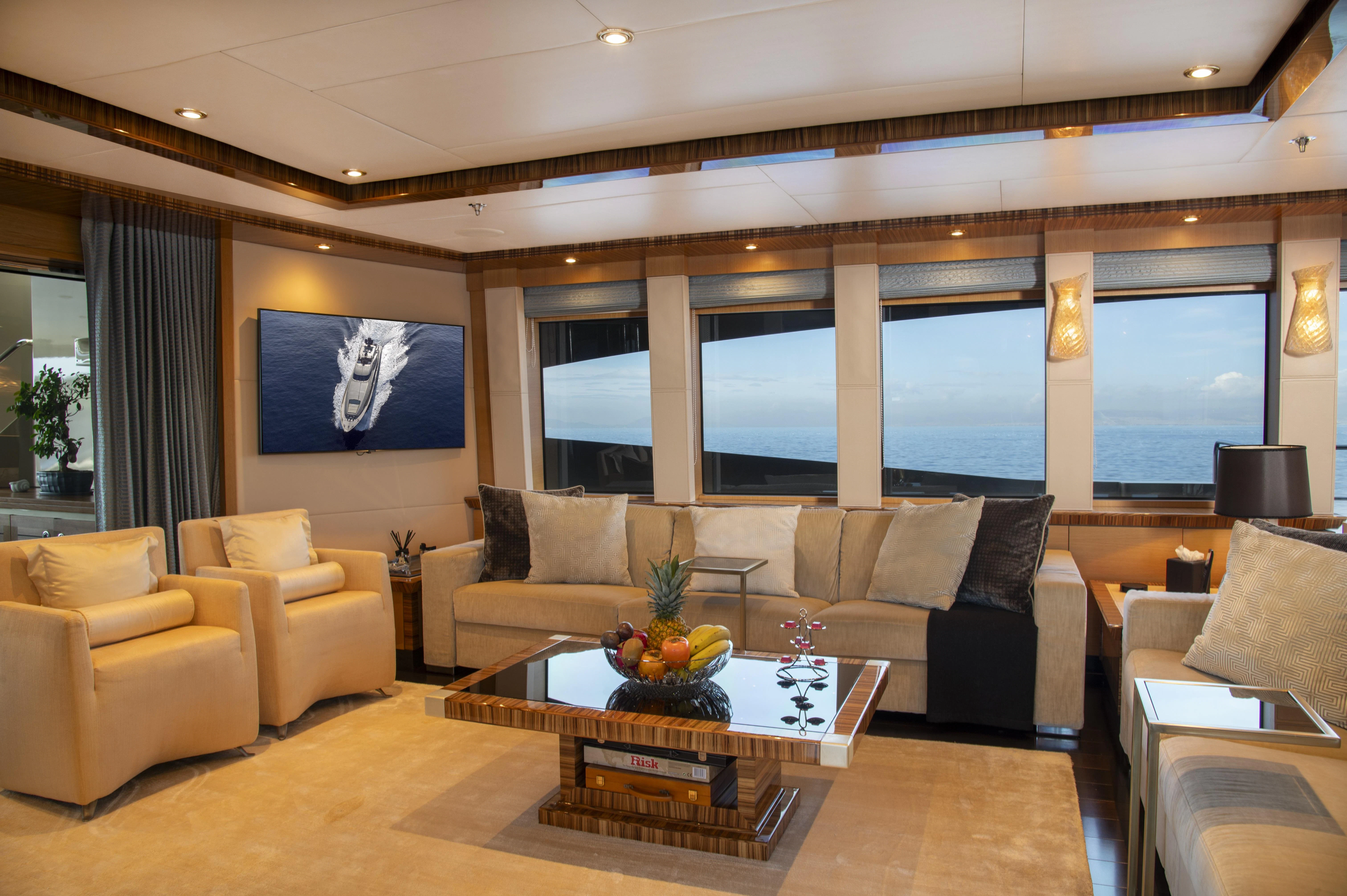 a living room with a large screen aboard HOKULANI Yacht for Sale