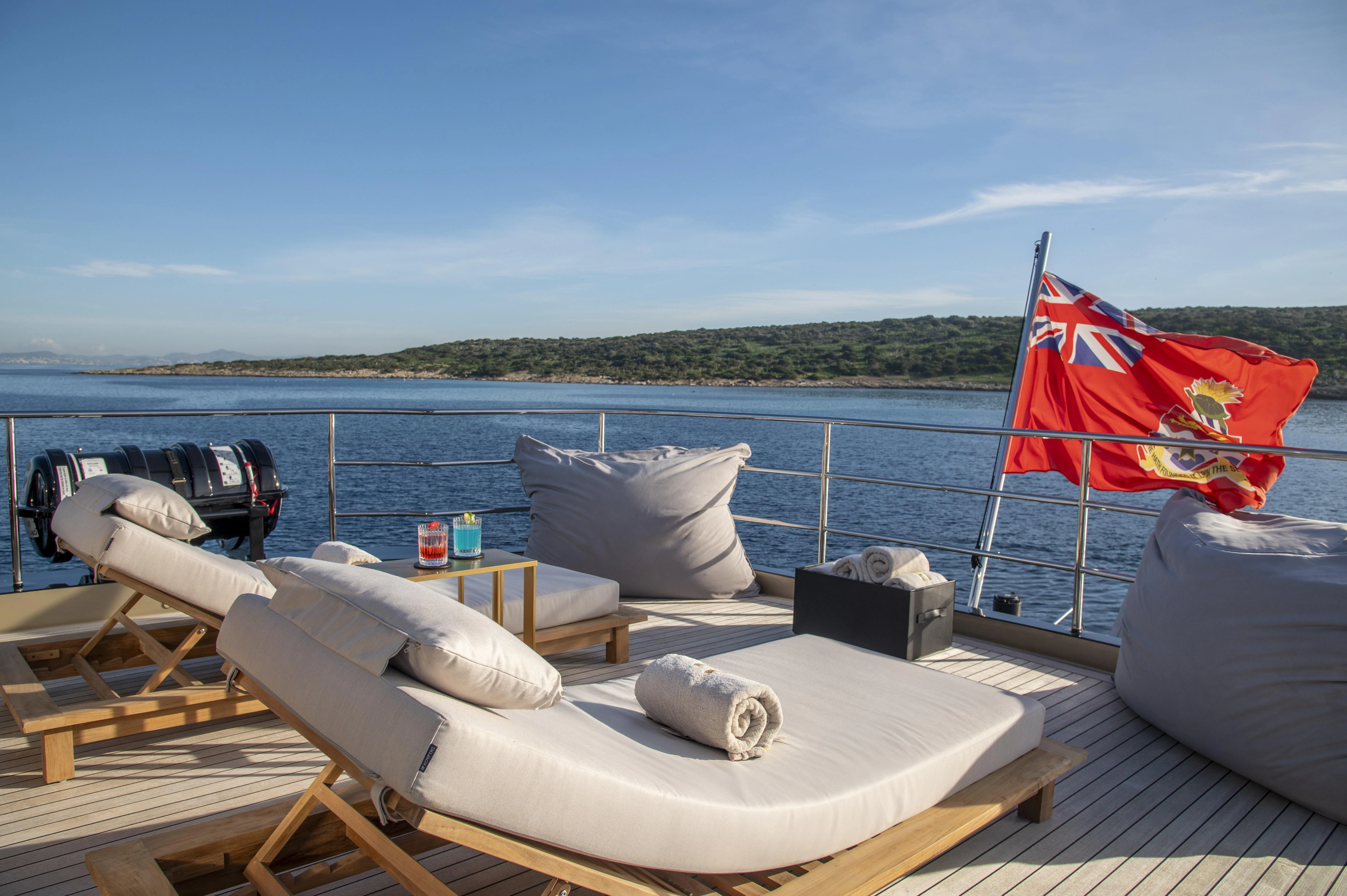 a boat with pillows on a deck aboard HOKULANI Yacht for Sale