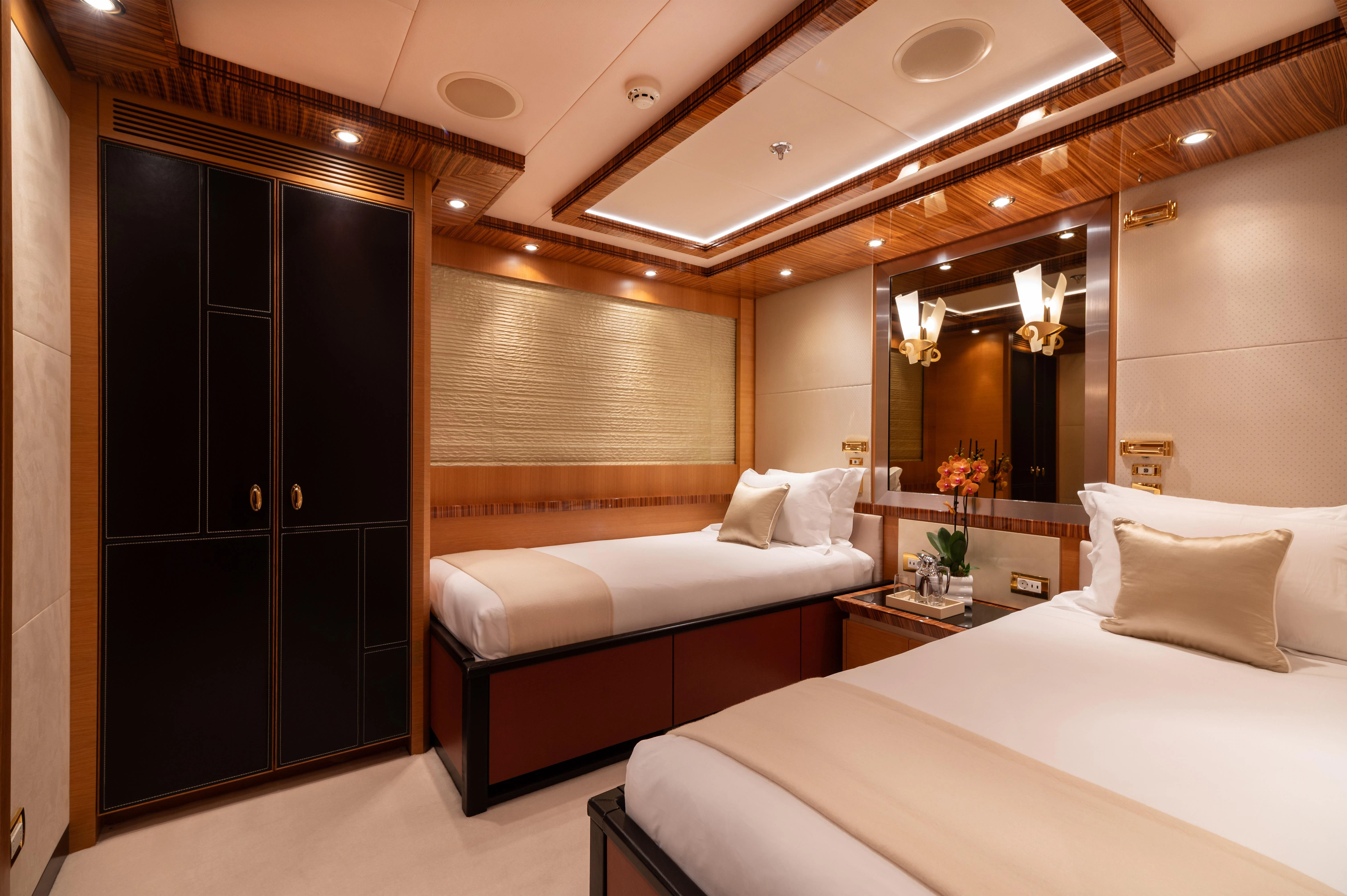 a room with a bed and a mirror aboard HOKULANI Yacht for Sale