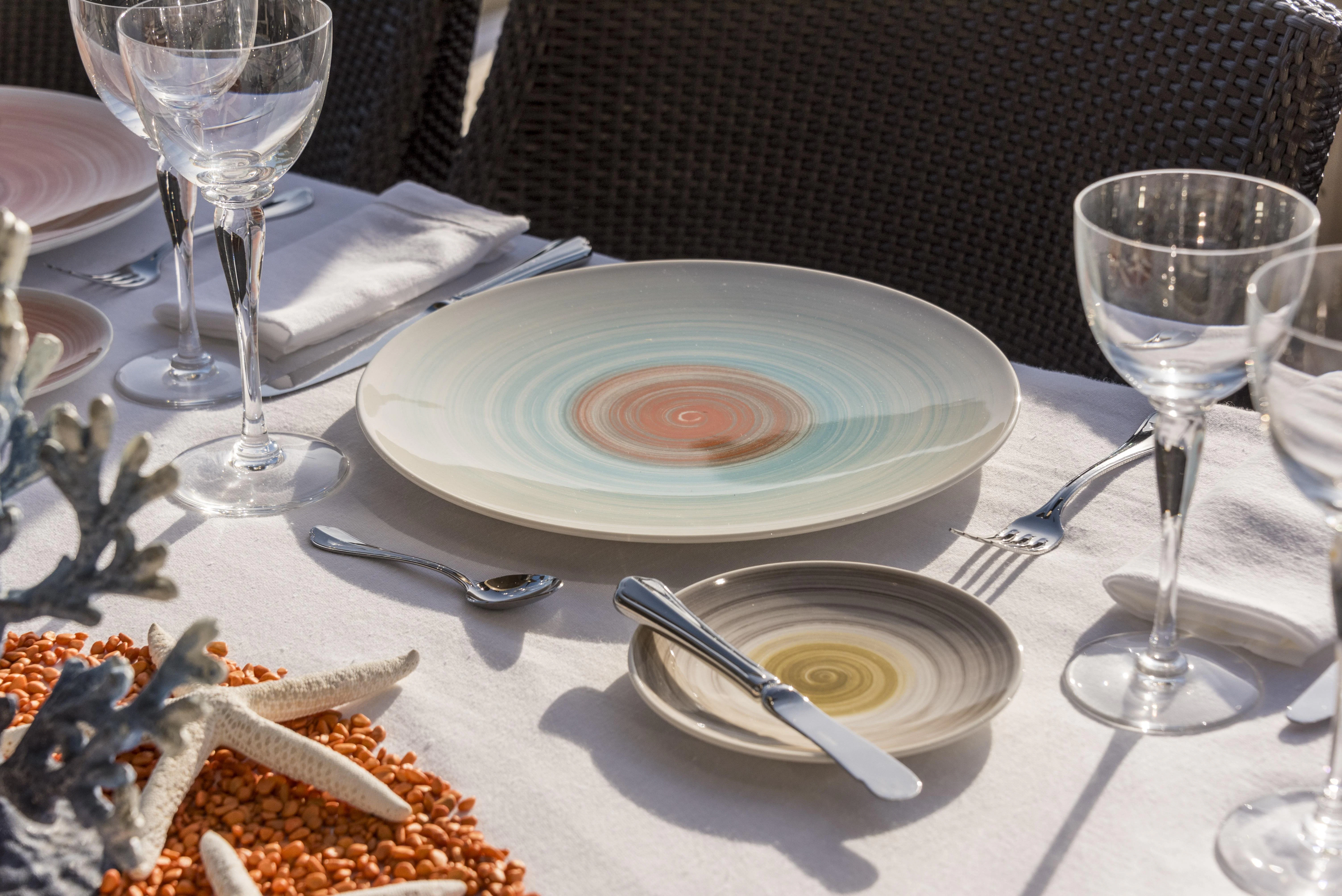 a table with plates and glasses aboard HOKULANI Yacht for Sale