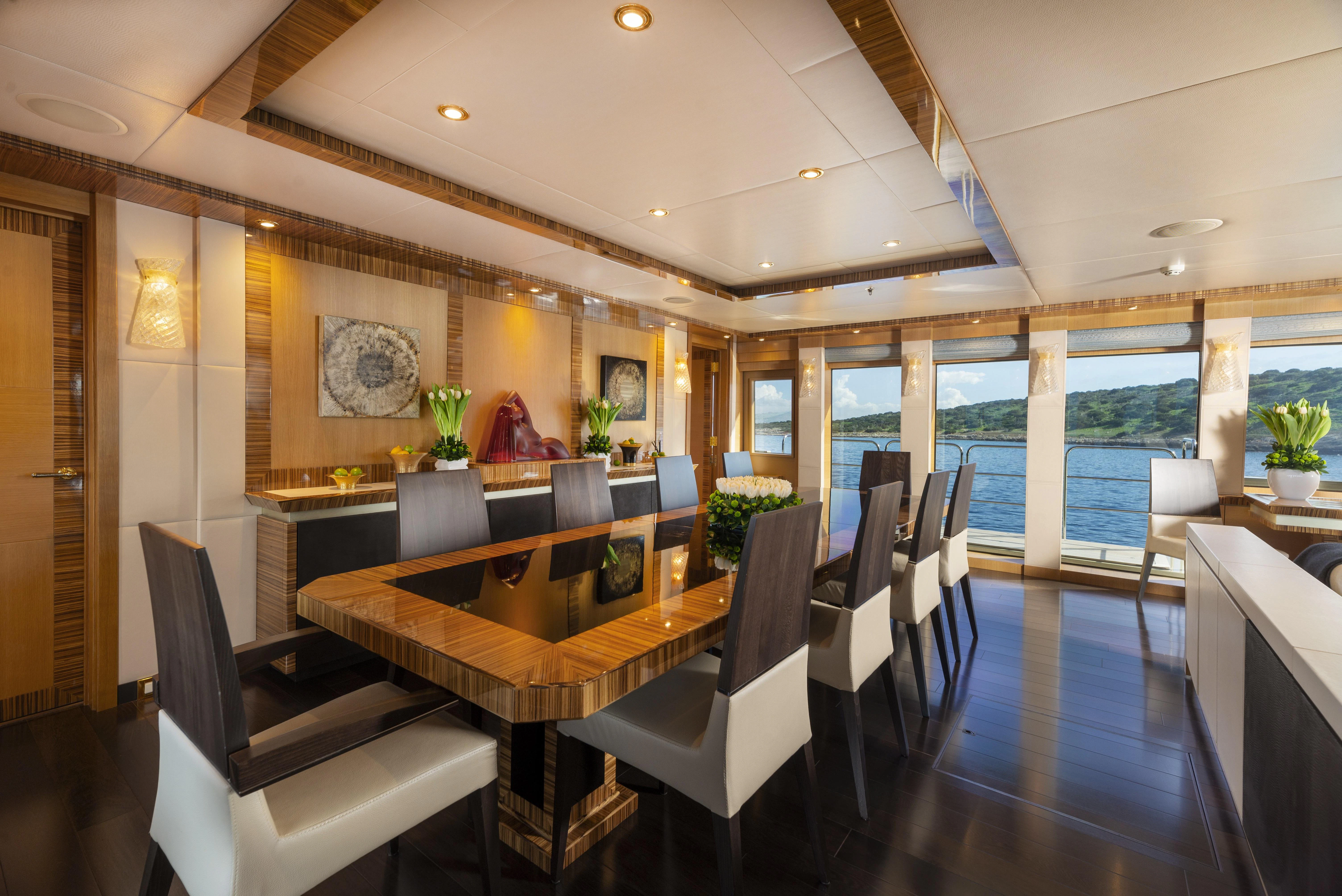 a large room with a table and chairs aboard HOKULANI Yacht for Sale