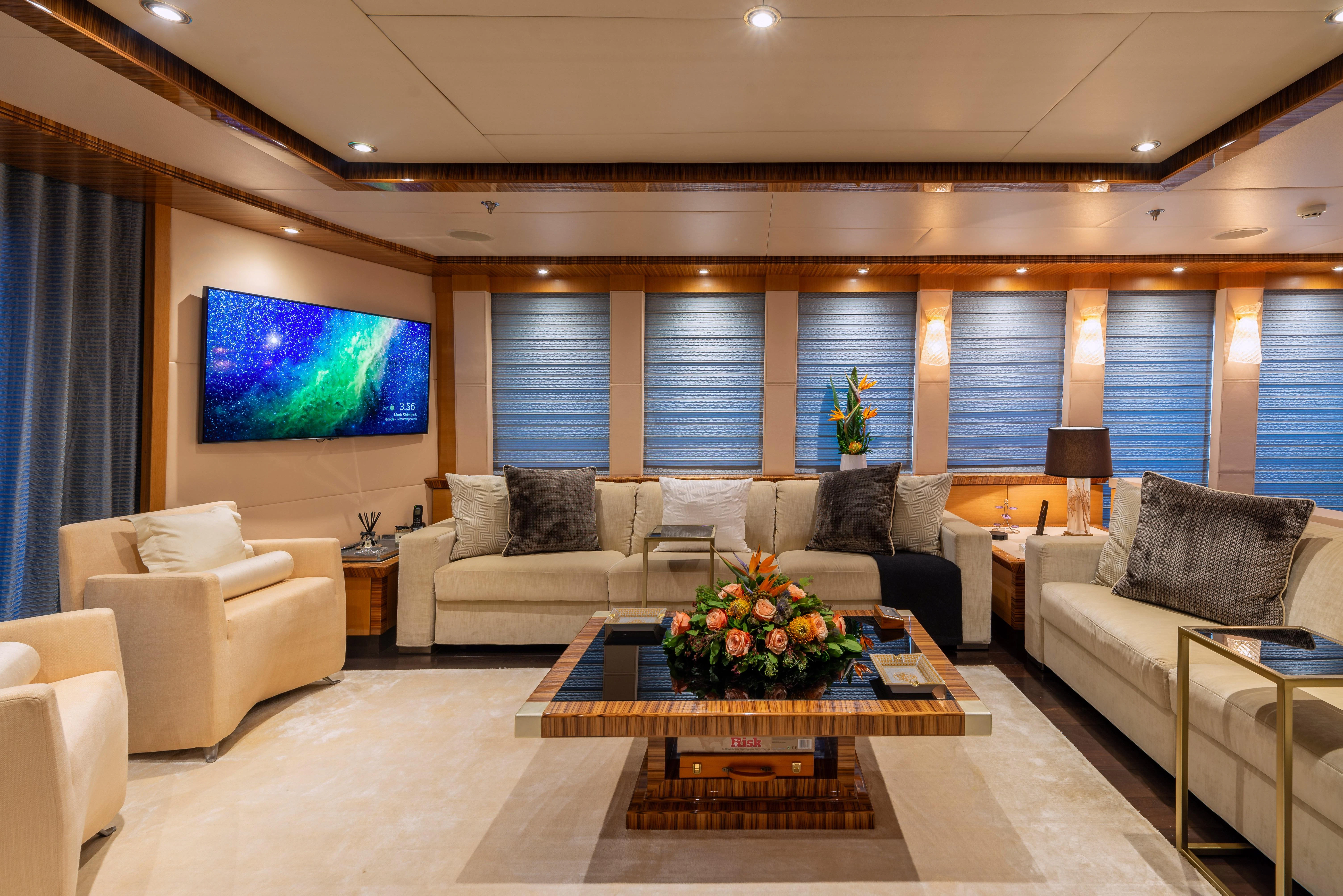 a living room with a large screen aboard HOKULANI Yacht for Sale