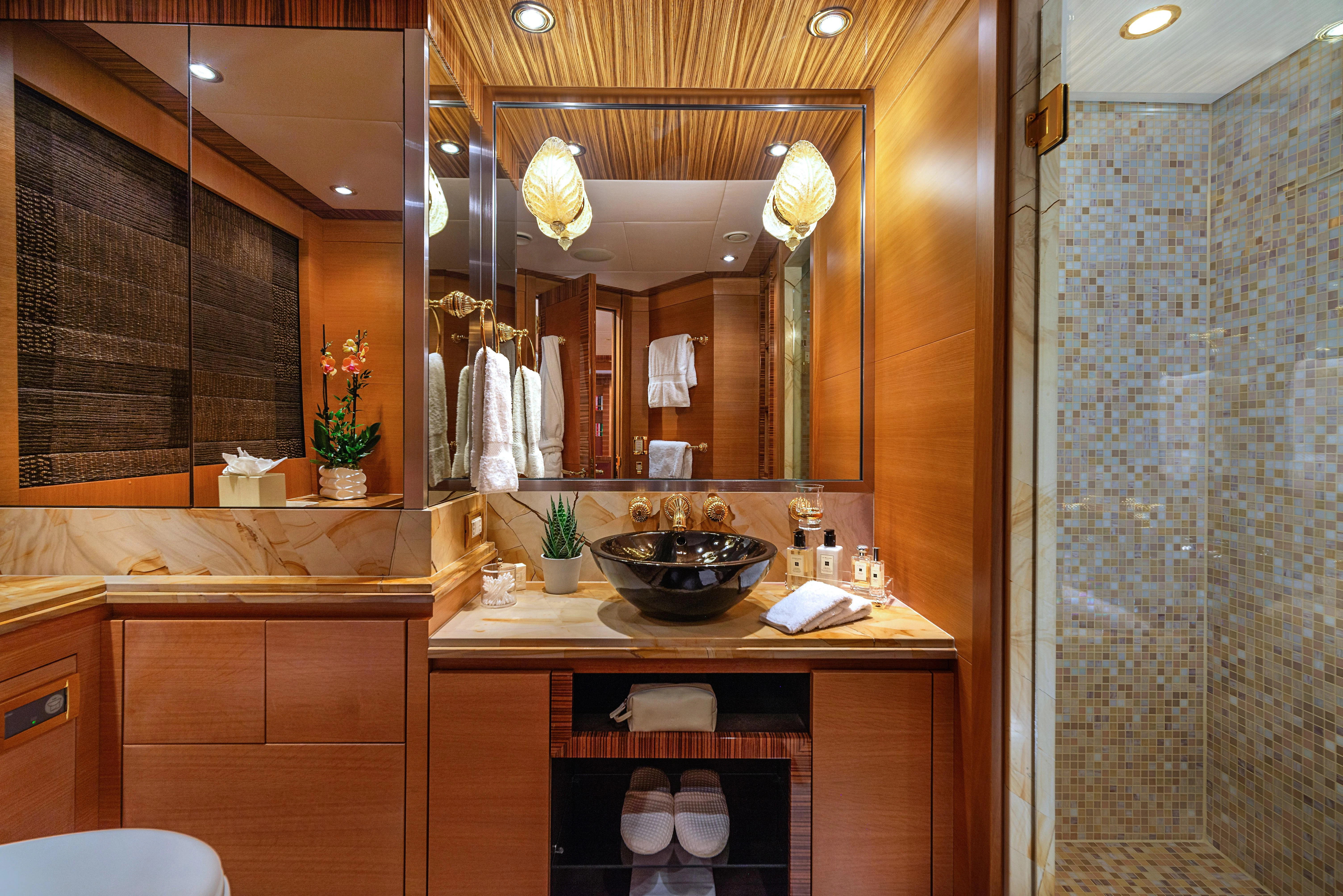 a bathroom with a large mirror aboard HOKULANI Yacht for Sale