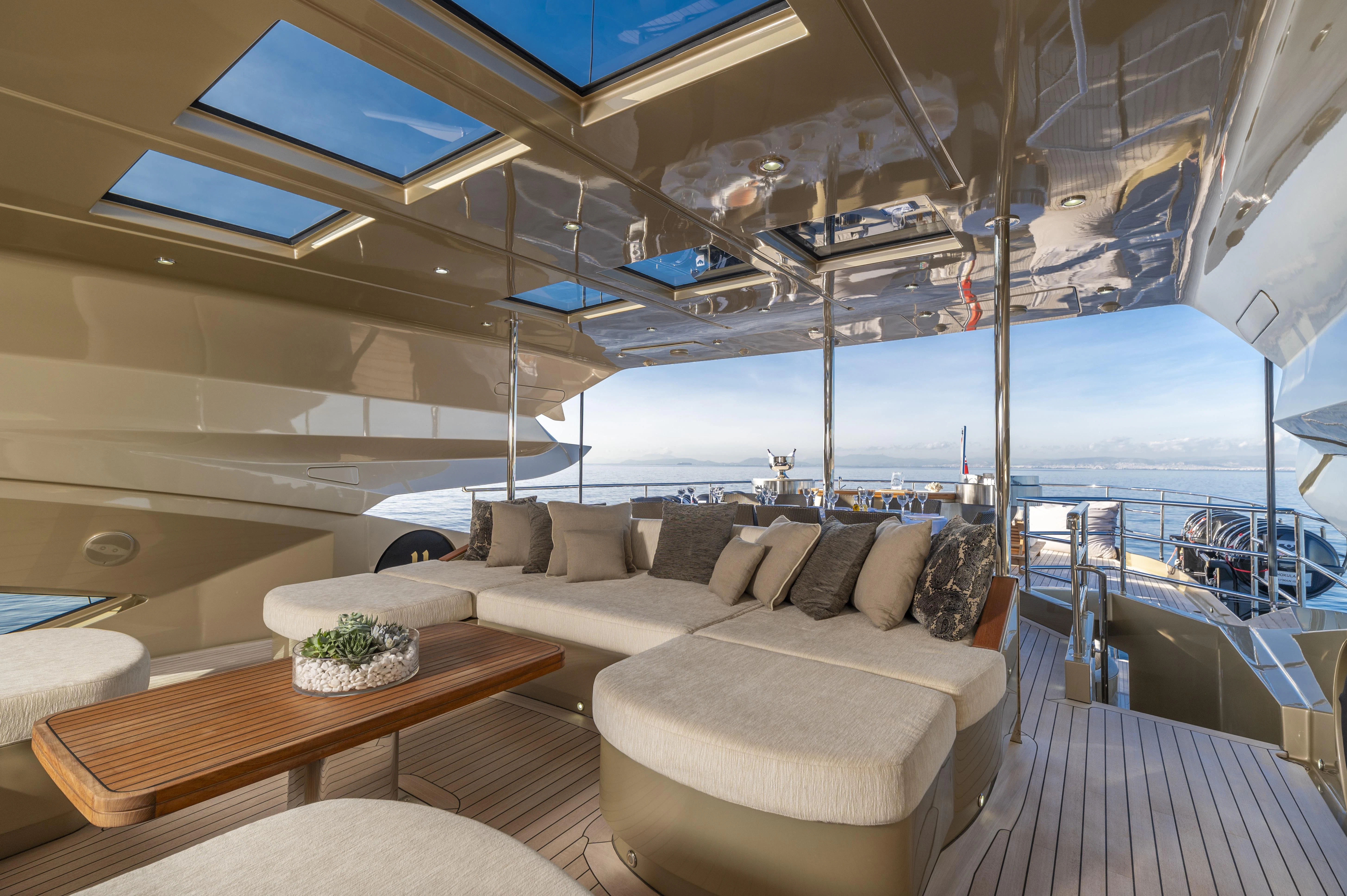a boat with a couch and a table aboard HOKULANI Yacht for Sale
