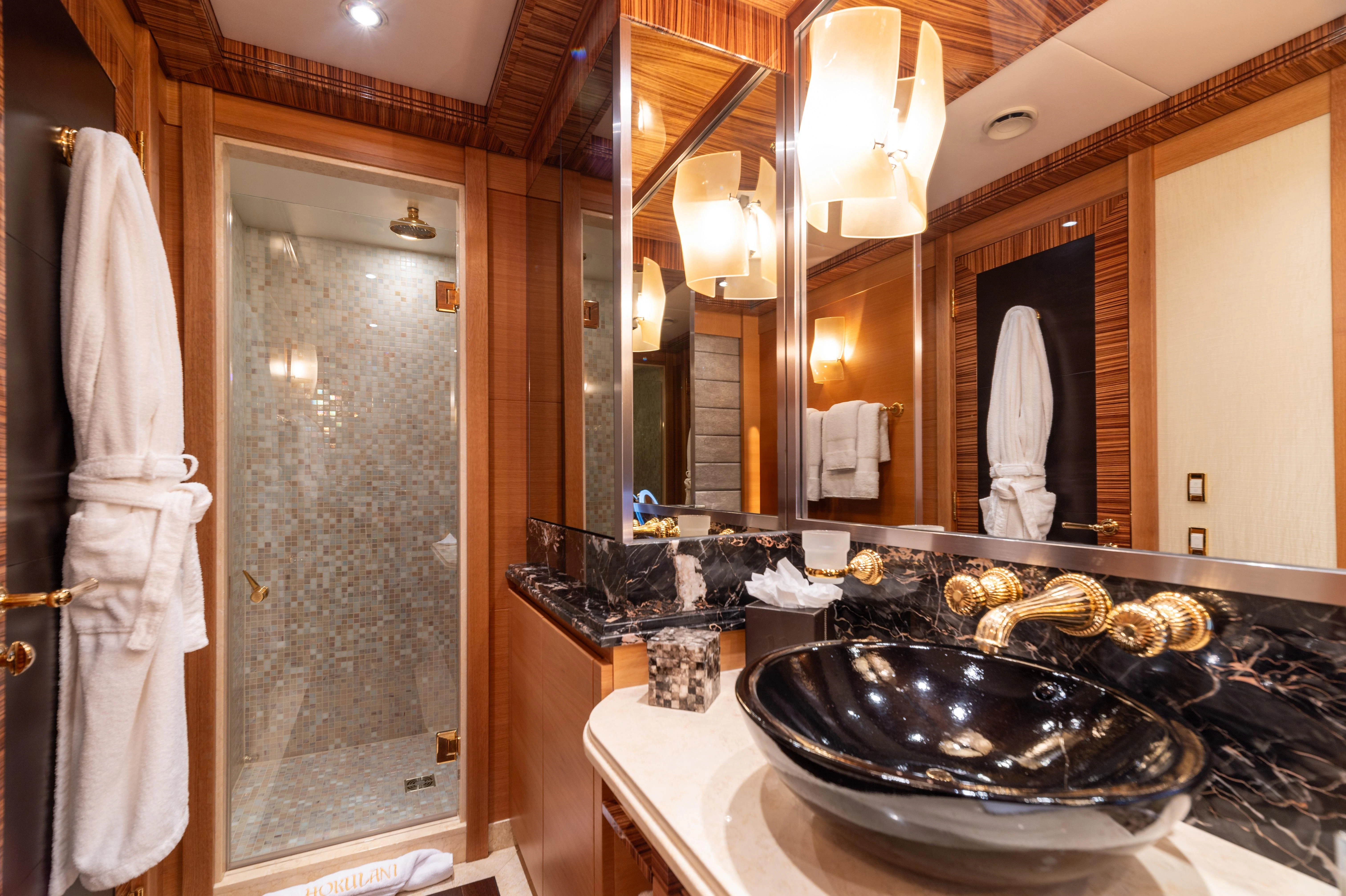a bathroom with a large mirror aboard HOKULANI Yacht for Sale