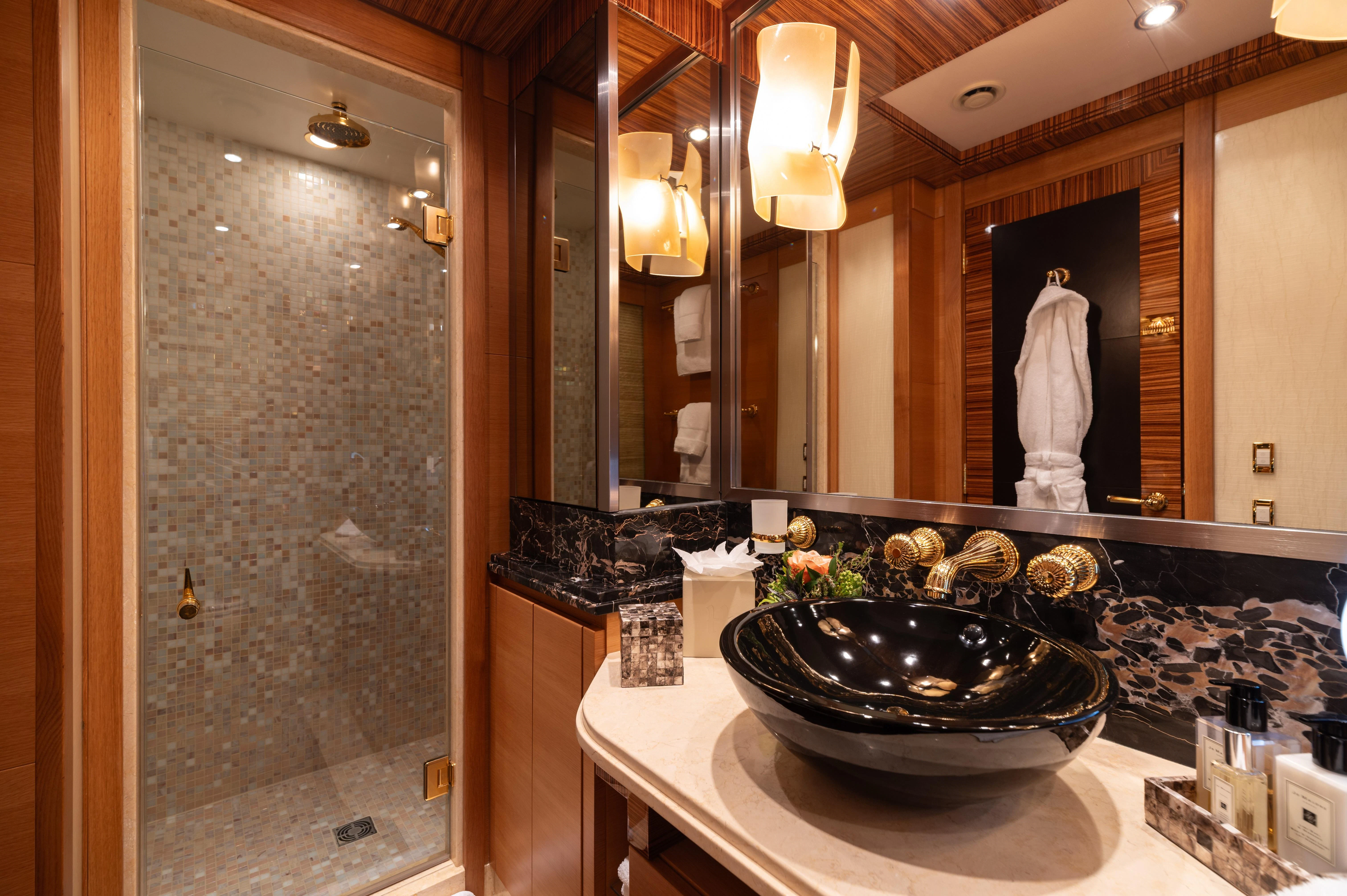 a bathroom with a large glass shower aboard HOKULANI Yacht for Sale