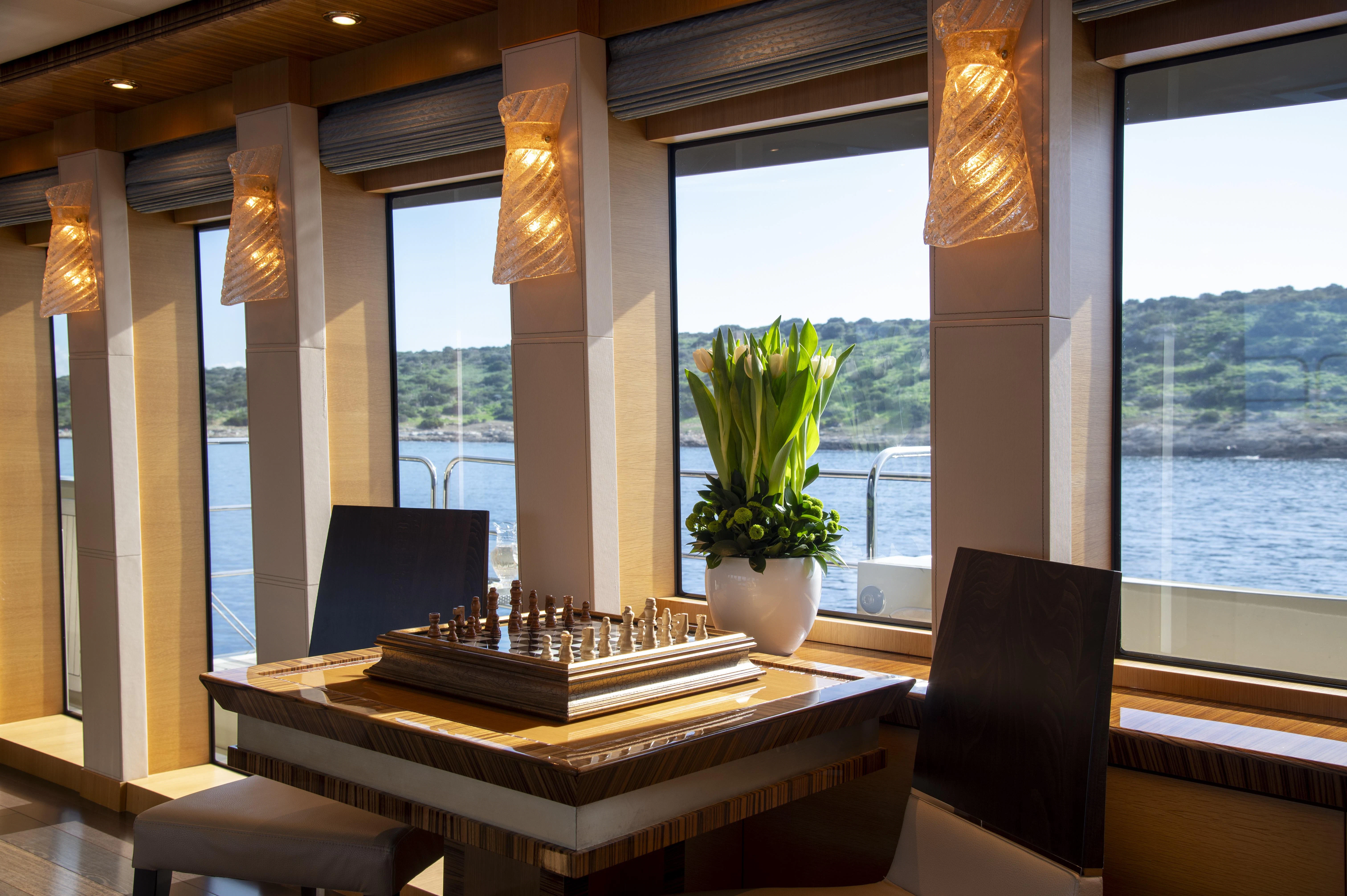 a room with a table and chairs aboard HOKULANI Yacht for Sale